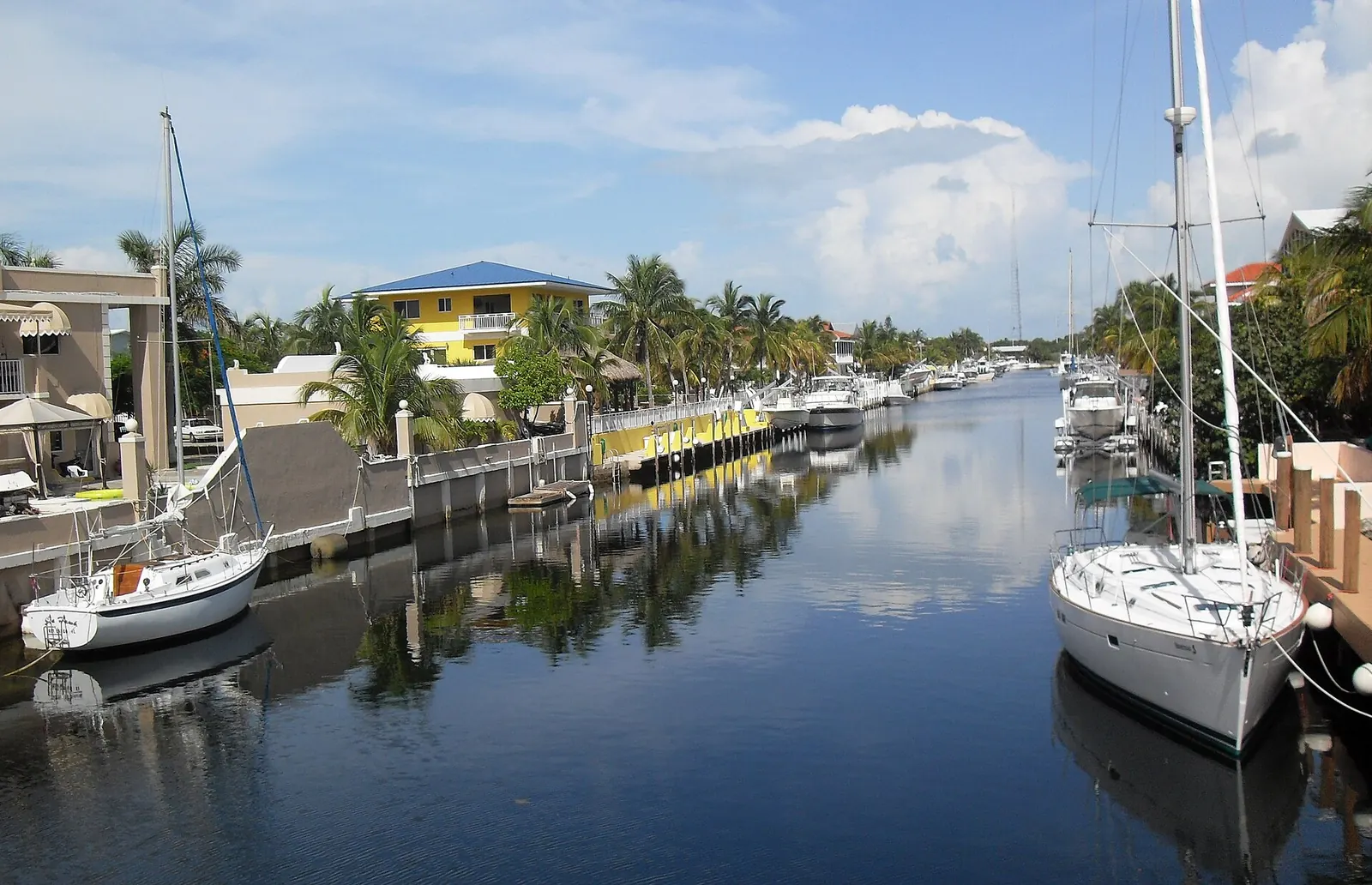 Concrete seawalls with capped edges lining a residential boat canal in Key Largo, Florida
